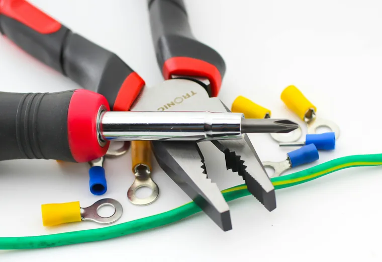 Wire stripper and small electrical hand tools on a workbench